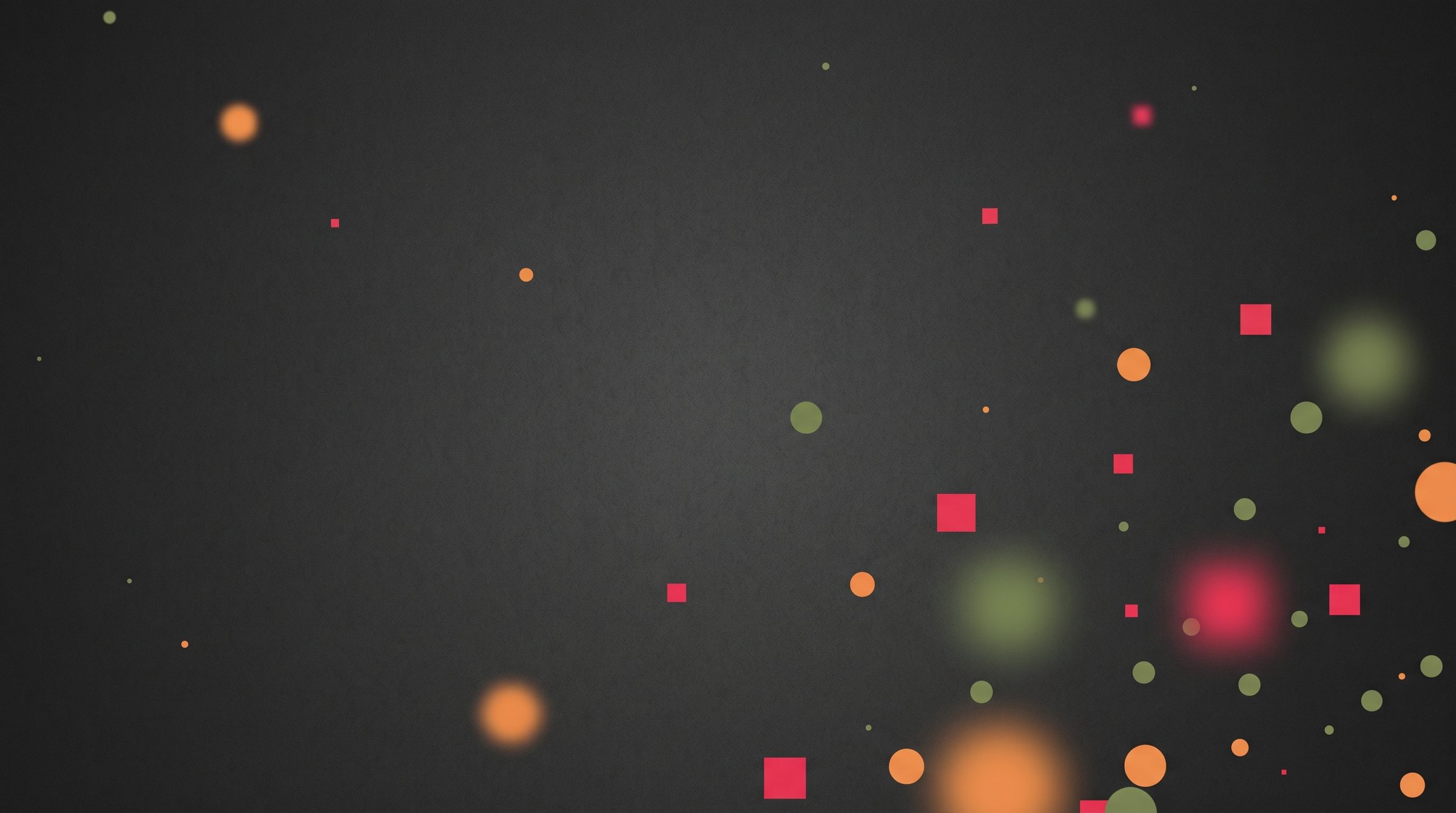 Green, orange and red circles and squares drifting out of focus across a dark graphite field